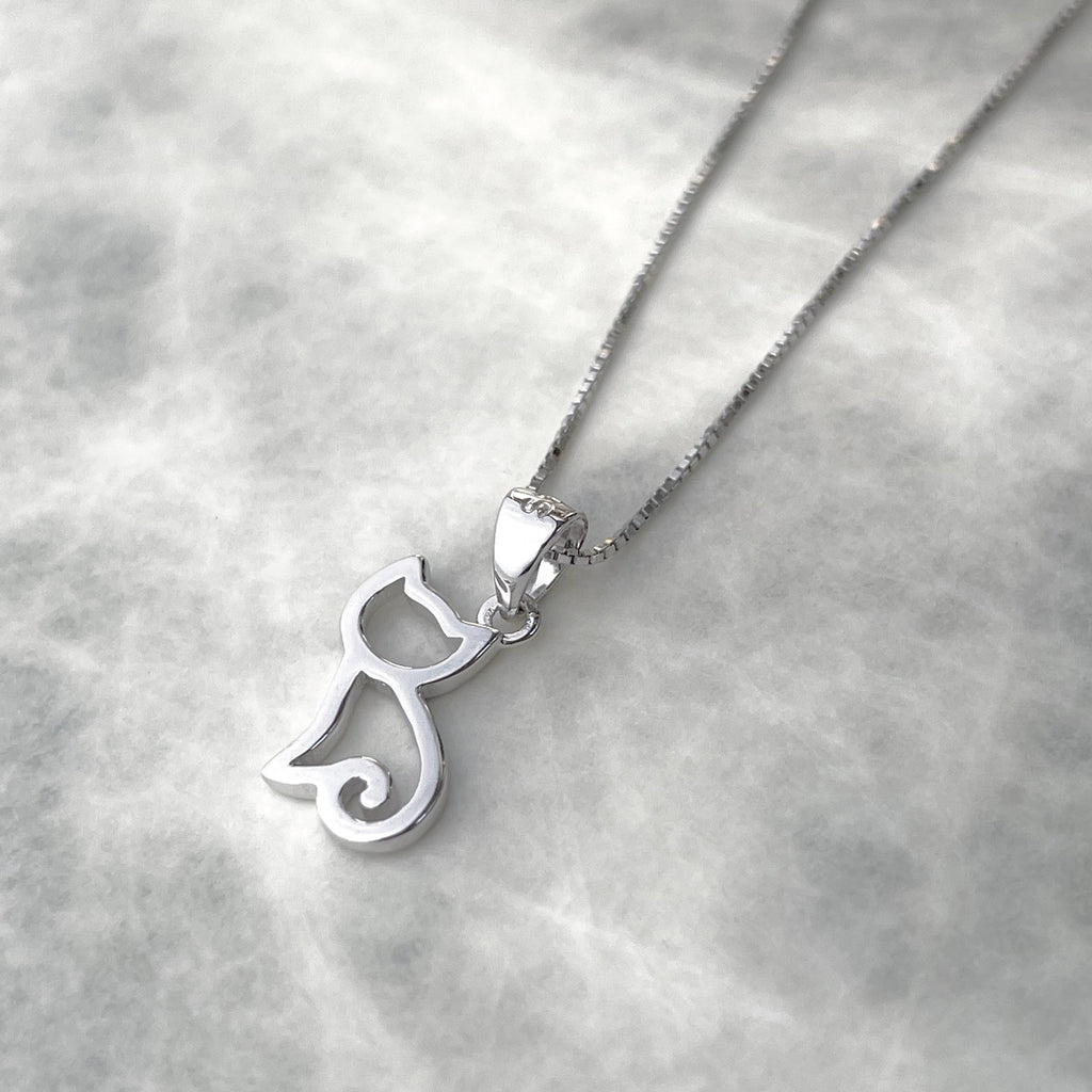 Silver cat-shaped pendant on a chain against a light gray background