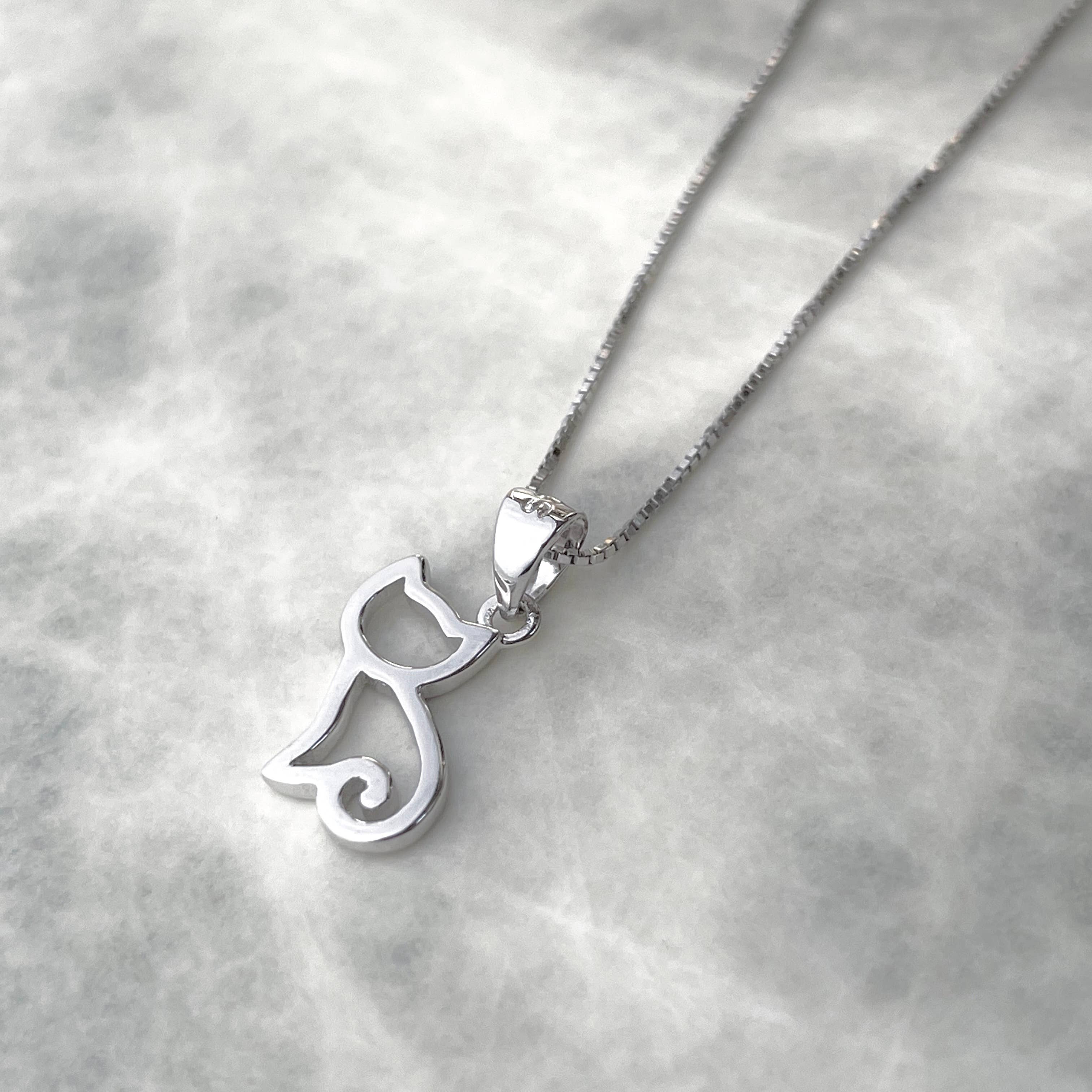 Silver cat-shaped pendant on a chain against a light gray background