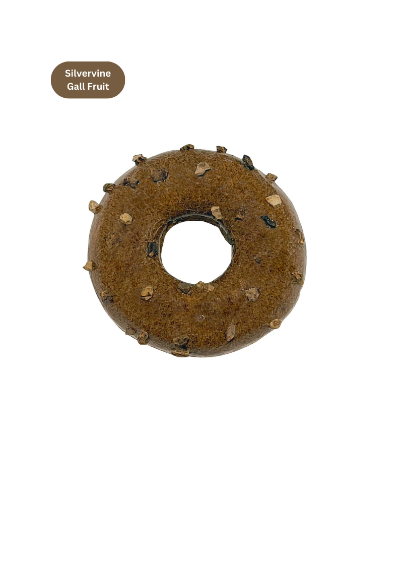 Donut-shaped treat with spikes on a white background