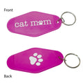 Two bright pink pet keychains shown on a white background, labeled Front and Back. The top keychain reads "cat mom" in white with a paw print icon, and the bottom keychain shows a large white paw print.