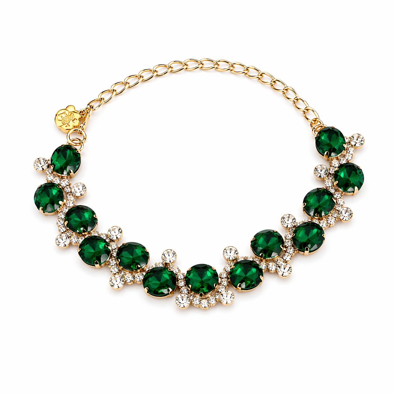 Gold bracelet with green gemstones on a white background