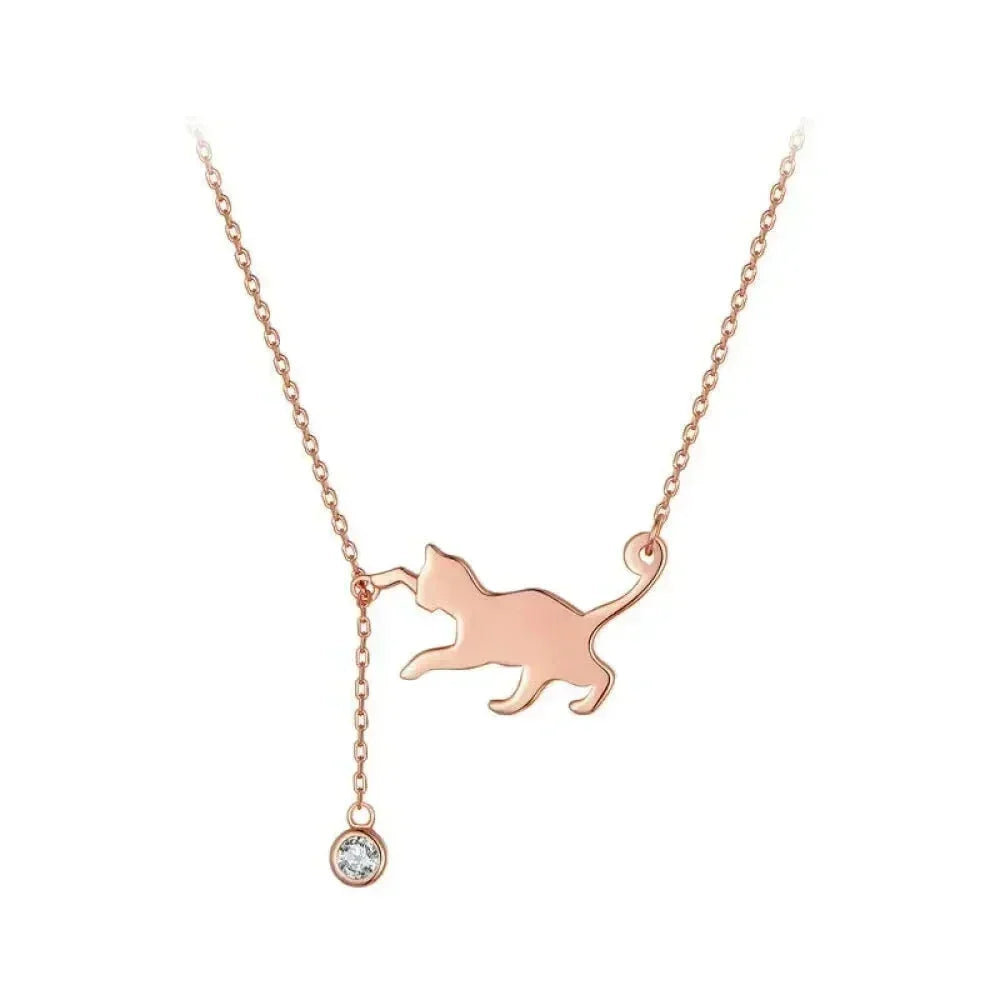 Rose gold cat-shaped pendant necklace with a small diamond on a white background