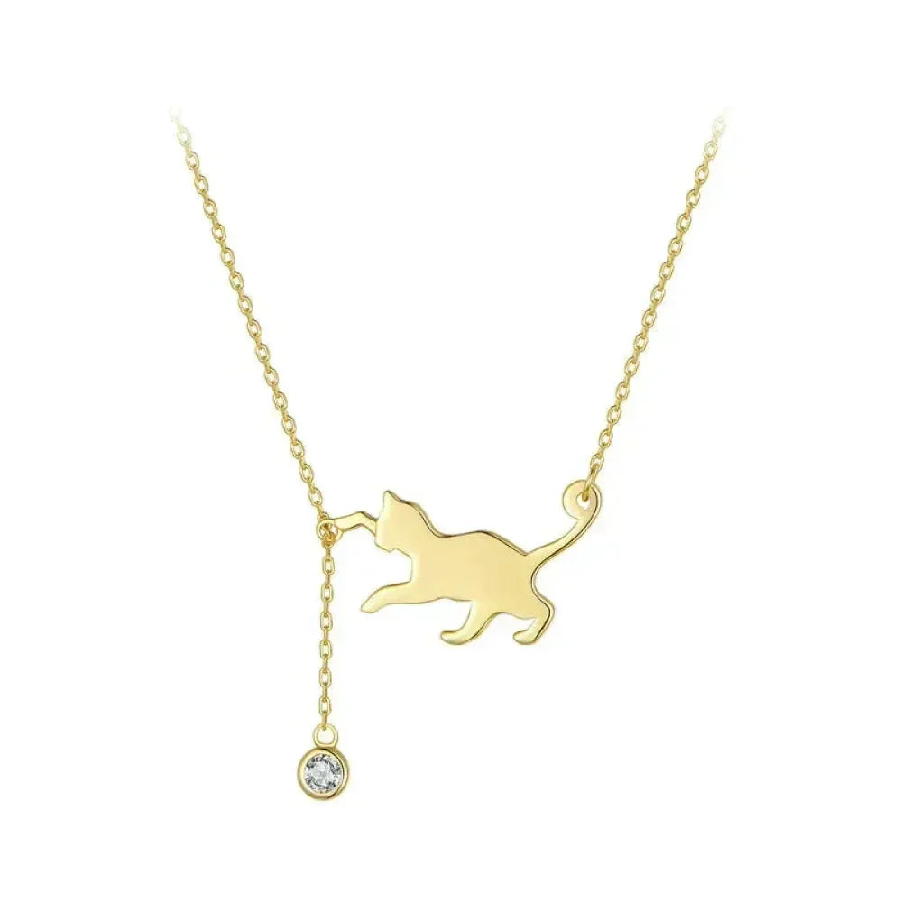 Gold cat-shaped pendant necklace with a small round gemstone on a white background