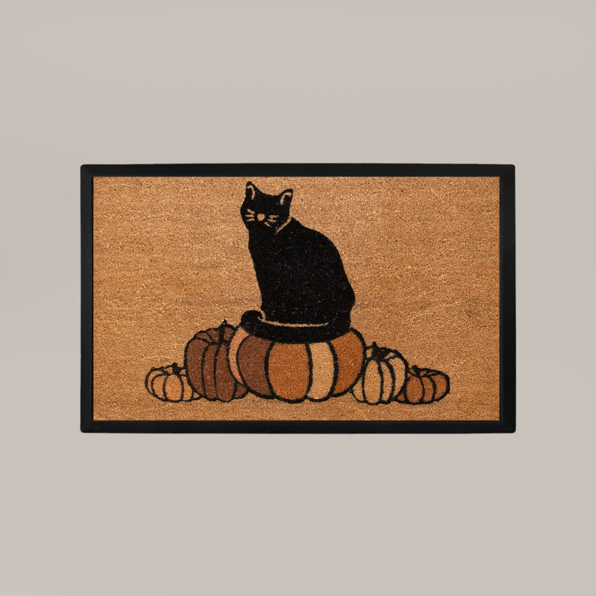 Doormat with a black cat and pumpkins design on a beige background