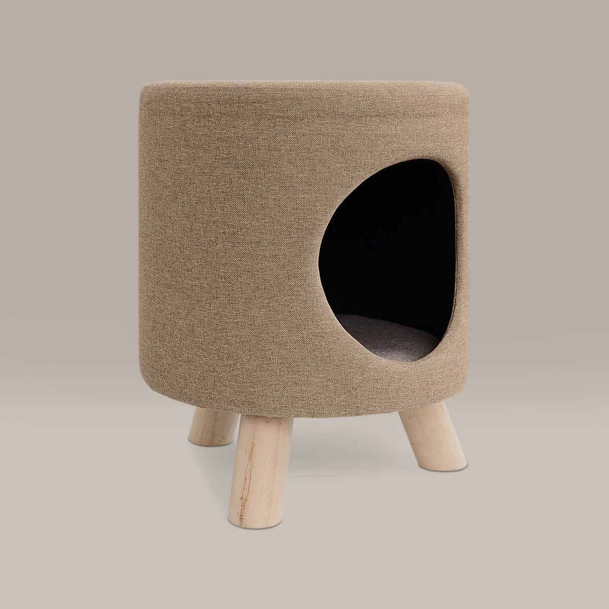 Beige pet bed with wooden legs on a beige background