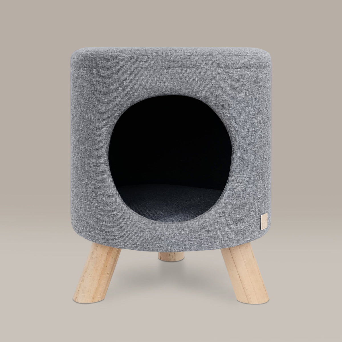 Gray pet bed with wooden legs on a beige background